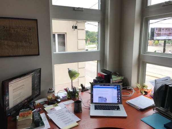 Corner Window Workspace with Computer and Papers